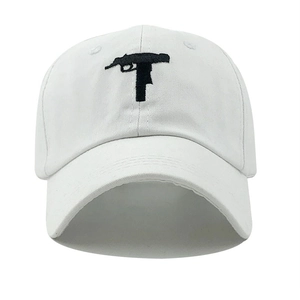 Detail of black machine gun embroidery on high-quality white cotton baseball cap