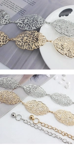 Detailed macro view of gold and silver hollow leaf metal waist chain with extension