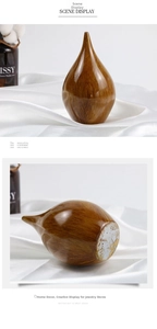 Teardrop-shaped home ornament with wood grain finish showing front view and base detail