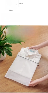Detail of a white fine mesh laundry bag for bras with a zipper protector and shell shape
