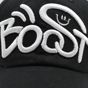 Close-up of black baseball cap featuring premium 3D white embroidery of BOOST and smile icon