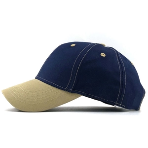 Side view of two-tone cotton twill baseball cap with navy crown and khaki curved brim
