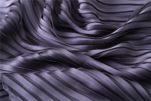 Detailed macro view of purple pleated satin fabric with elegant silk-like sheen texture