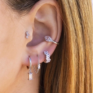 Elegant silver s925 earring set with white cubic zirconia worn as a stack