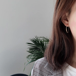 Elegant 925 sterling silver U-shaped gold earrings worn by a model in a modern style