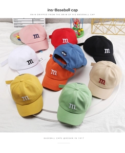 Top view of colorful kids cotton baseball caps with m embroidery and adjustable metal buckle
