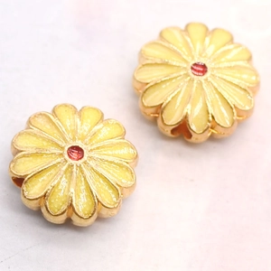 Detail of sunflower enamel bead with yellow petals and red center for jewelry making
