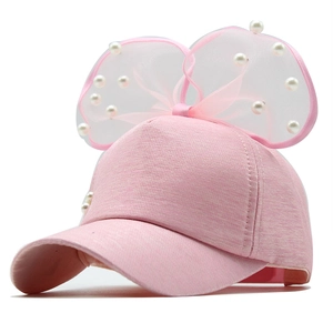 Detailed view of pink girls' mesh cap featuring a large lace bow and elegant pearls