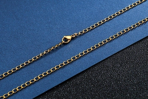 Close-up of a gold-toned stainless steel link chain with a secure lobster claw clasp