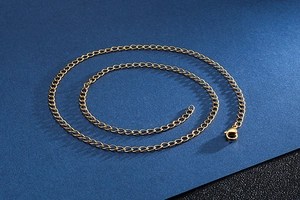 Detailed macro view of a gold-toned stainless steel link chain with a secure lobster clasp
