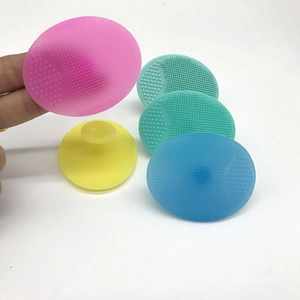 Close-up of silicone facial cleansing brushes in multiple colors with suction cups