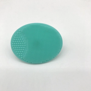 Macro detail of soft mint green silicone facial cleanser brush with pore cleaning bristles