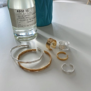Close-up of irregular hammered texture on S925 sterling silver rings and bangles