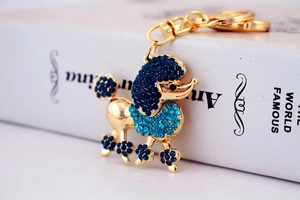 Detail of creative blue crystal poodle keychain with golden metal ring and lobster clasp