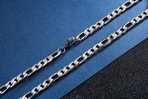 Macro detail of 9mm silver stainless steel chain links with a secure lobster clasp