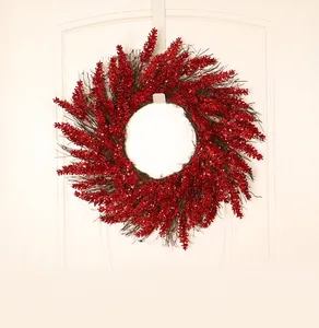 Close-up of a red glitter berry wreath hanging on a white wooden front door decoration
