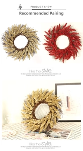 Close-up of festive Christmas wreath with golden leaves and red berries for home decor