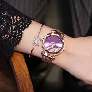 Detail of rose gold swan watch set with purple rhinestone dial and matching bracelet