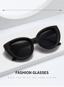 Modern matte black cat-eye sunglasses with dark lenses displayed on a white platform