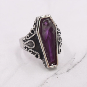 Detailed macro view of Gothic coffin ring with purple enamel and vintage silver scrollwork