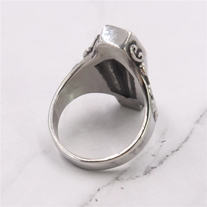 Macro view of gothic silver coffin ring showing detailed side patterns and hollow interior