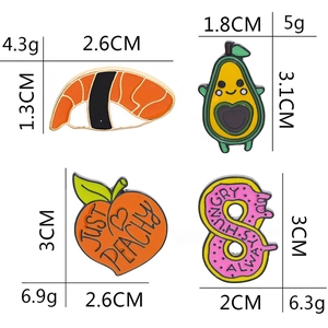 Detail view of sushi, avocado, peach, and donut enamel pins with sizes and weights