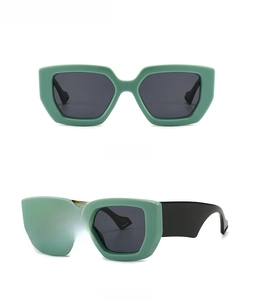 Front and side view of modern oversized light green sunglasses with dark grey lenses