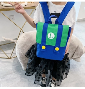 Detail view of the colorful kids backpack featuring a green L logo and yellow buttons