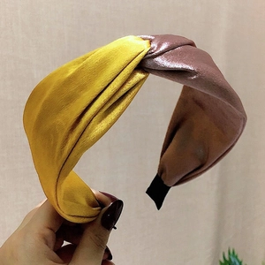 Elegant twisted satin headband with golden yellow and brownish-purple color-blocking design