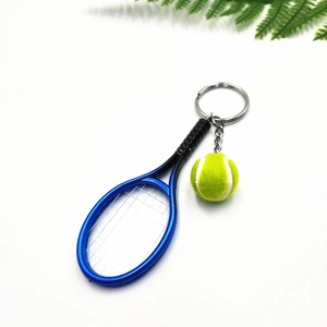 Detail of mini tennis racket and ball keychain set with realistic mesh and texture