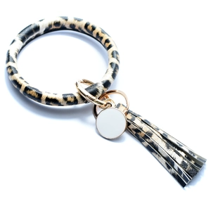 Detail of leopard print PU bangle keychain with gold ring, tassel and round charm