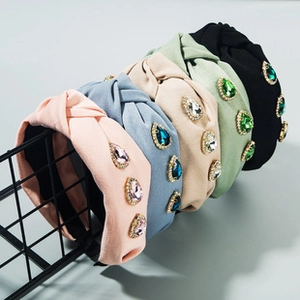 Detail of wide knotted fabric headbands with large teardrop rhinestones in five colors
