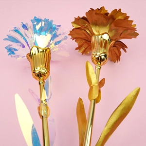 Detail of colorful holographic and reddish-brown gold foil carnations with golden stems