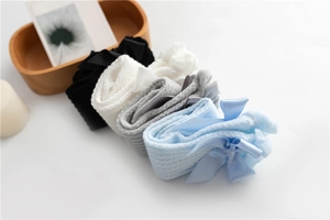 Detailed view of breathable mesh baby socks with satin bows in four assorted colors