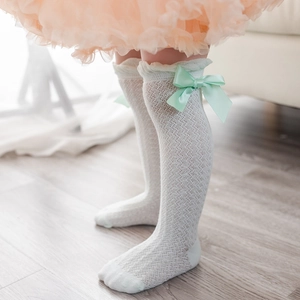 White mesh baby socks with ruffle trim and light green satin bow for summer wear