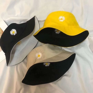 Daisy embroidery reversible cotton bucket hat in yellow, black, and beige for sun protection