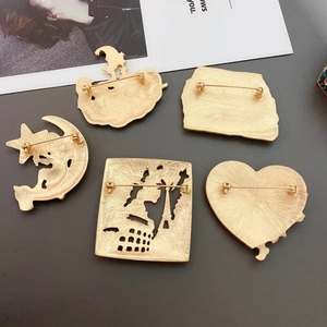Detailed set of five matte gold brooches featuring Baroque relief and landmark silhouettes