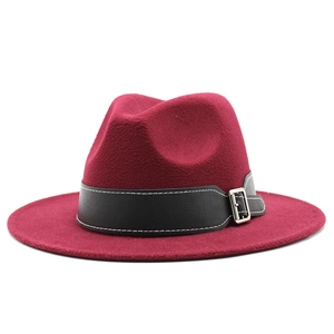 Detail of burgundy wide brim wool fedora with black leather belt and silver metal buckle
