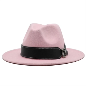 Detail of pink wool fedora hat featuring black faux leather band and silver metal buckle