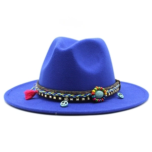 Detailed view of navy wool jazz hat with ethnic braided band and peace sign pendant