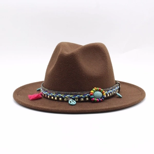 Detail of dark brown wool fedora hat featuring ethnic woven band and turquoise disc charm