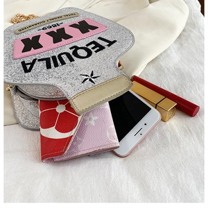 Internal view of a silver sequin tequila bottle shaped bag with a spacious interior