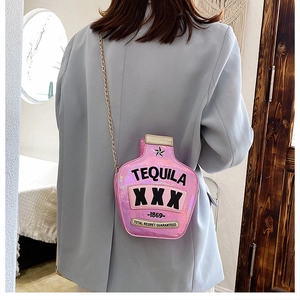Pink laser sequins tequila bottle crossbody bag with gold chain strap on model