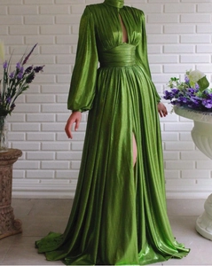 Detail of avocado green pleated maxi dress with high neck, cutout, and lantern sleeves