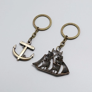 Vintage bronze nautical keychain set with detailed anchor and sailing ship pendants