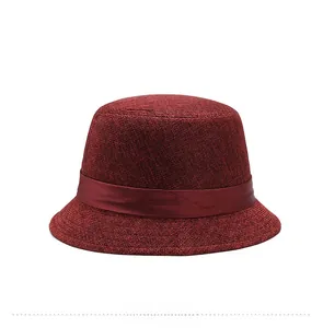 Detailed back view of a burgundy woven fascinator hat with elegant satin ribbon accent