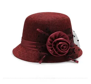 Detail of burgundy linen cloche hat with a large satin rose and black polka dot mesh