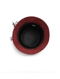 Detailed interior view showing dark red cloche hat lining and black polka dot bow detail