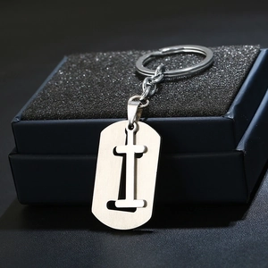 Macro shot of silver stainless steel letter I keychain with brushed metal texture detail
