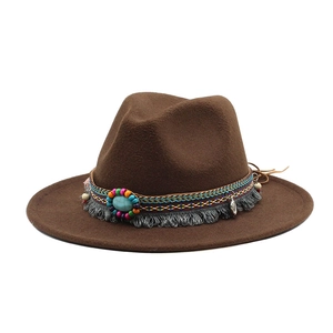 Detail of bohemian wool fedora with ethnic tassel band, turquoise stone and coins